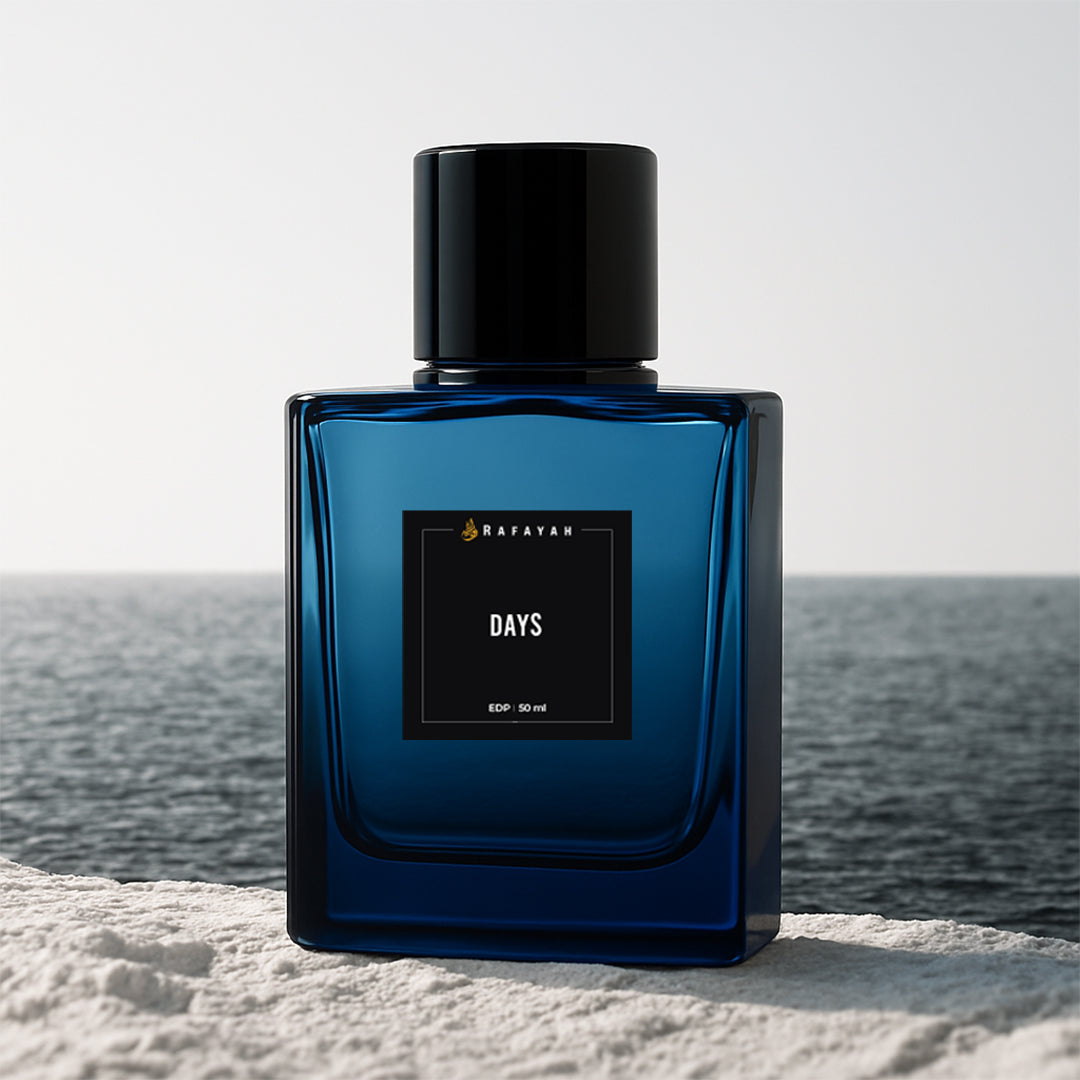 Blue Rafayah Days perfume bottle on stone by the ocean