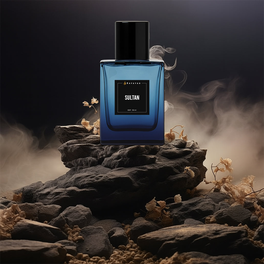 Sultan perfume bottle on dark rocks with dry flowers and dramatic mist